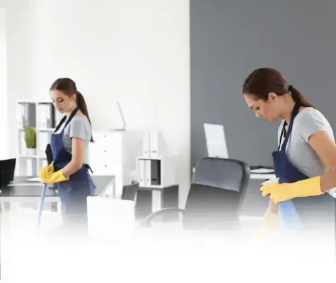 Office cleaning service professional sanitizing a commercial desk and workstation